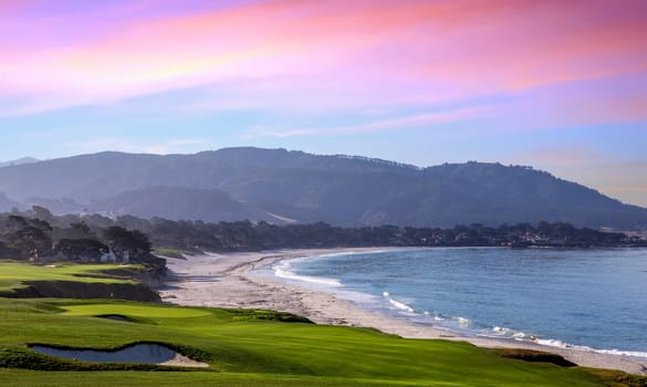 oceanside golf course with bunker,  ocean and clouds