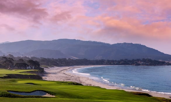 oceanside golf course with bunker,  ocean and clouds