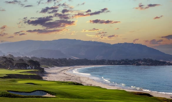 oceanside golf course with bunker,  ocean and clouds