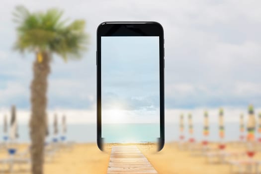 Mobile phone screen with beach umbrella on the sandy beach. Summer concept