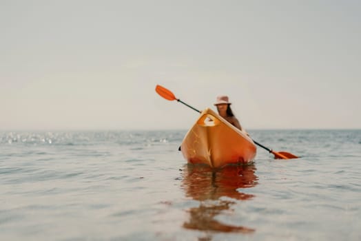 Kayak sea woman. Happy attractive woman with long hair in red swimsuit, swimming on kayak. Summer holiday vacation and travel concept