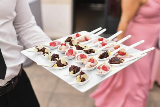 Waiter serving small appetizers at a wedding Catering