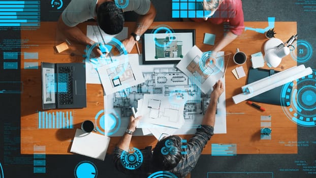 Top down view of engineer planning and writing at blueprint. Architect team working together to design building construction while sitting at meeting table with financial chart holographic. Symposium.