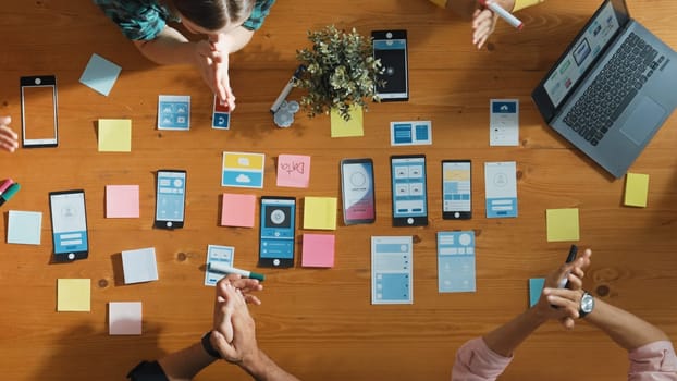 Creative team clapping hand together while brainstorm about Ux Ui design mobile phone interface. People planning strategy start up project while planning a strategy at business meeting. Convocation.