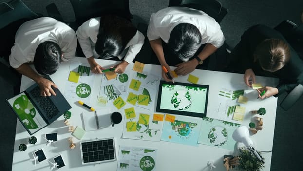 Top view of executive manager hold tablet display clean energy at meeting. Aerial view of business people working together to plan and invest in sustainable environmental investment. Alimentation.