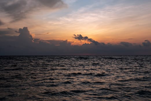 Amazing colors of tropical sunset. Travel concept. Ocean waves wash the sand. Boracay island, Philippines.