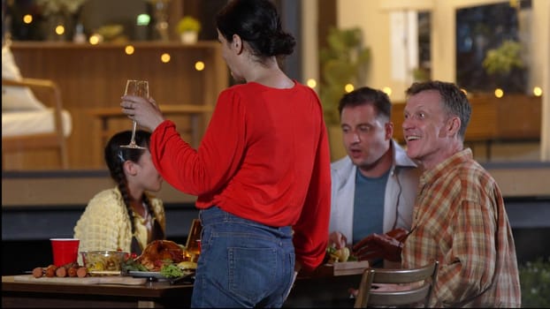 Family gather celebrate holiday. Parents, grandparents and cute girl together talk and have dinner party food. Outdoor activity for spending time with multigeneration cross generation gap. Divergence.