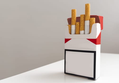 Open pack of cigarettes and a cigarette on a white background. High quality photo