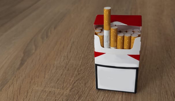 Pack of cigarettes on wooden textured table. High quality photo
