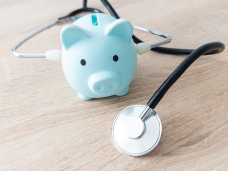 Piggy bank with medical equipment on the table medical concepts and health insurance. High quality photo