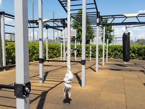 Close up of outdoor playground monkey bars on blue sky day with clouds. High quality photo