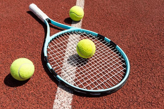 Tennis scene with balls, racquets and hard court surface corner lines. High quality photo