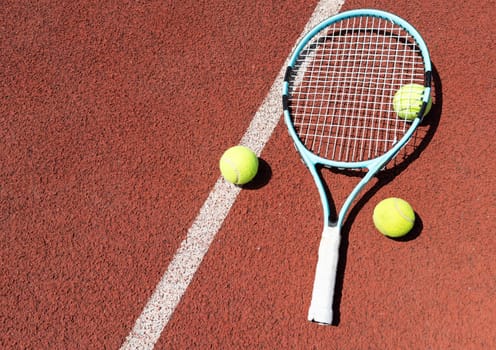 Tennis scene with balls, racquets and hard court surface corner lines. High quality photo