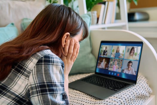 Laptop screen with online video conference by group of teenage students, young female in home talking to students. Education, wireless technology, e-learning, virtual lessons, distance learning