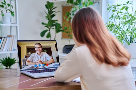 Young female on online therapy with psychologist psychotherapist, using video conference call on laptop. Technology, health care, mental support social services, psychology psychotherapy youth concept
