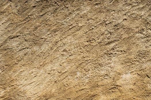 A detailed close-up of a textured sand background with intricate patterns and variations in color.