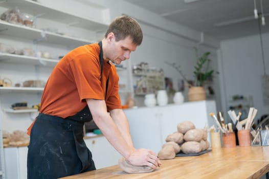 Potter kneads clay before using it in the workshop