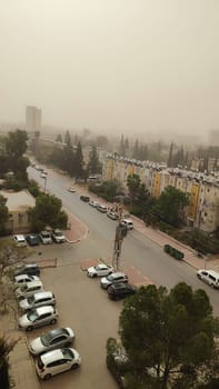 street city houses cars, gray sky smog. High quality photo