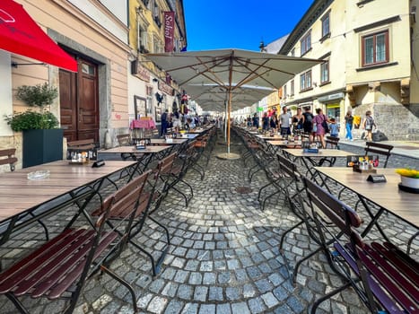 Restaurant garden with tables and a chair. Visiting the capital of Slovenia. A place for coffee or a meal