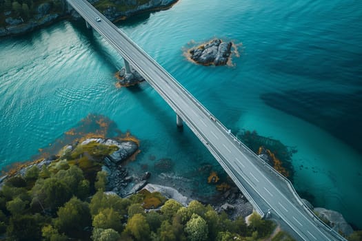 A birds eye view of a bridge spanning a body of water, connecting two land masses.