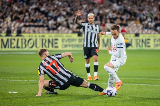 MELBOURNE, AUSTRALIA - MAY 22: James Maddison of Tottenham Hotspur sidesteps Emil Krafth of Newcastle United during the Global Football Week at The Melbourne Cricket Ground on May 22, 2024 in Melbourne, Australia
