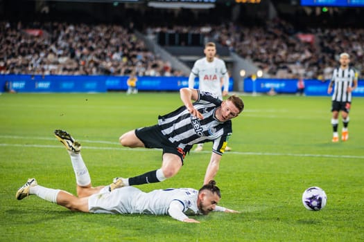 MELBOURNE, AUSTRALIA - MAY 22: Radu Dragusin of Tottenham Hotspur clashes with Elliot Anderson of Newcastle United during the Global Football Week at The Melbourne Cricket Ground on May 22, 2024 in Melbourne, Australia