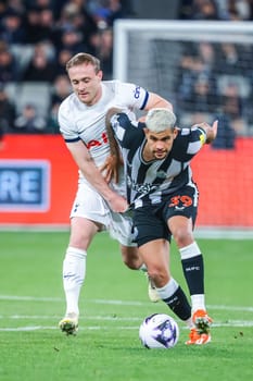 MELBOURNE, AUSTRALIA - MAY 22: Oliver Skipp of Tottenham Hotspur and Bruno Guimaraes of Newcastle United tussle for the ball during the Global Football Week at The Melbourne Cricket Ground on May 22, 2024 in Melbourne, Australia