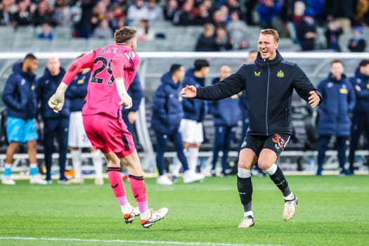 MELBOURNE, AUSTRALIA - MAY 22: Mark Gillespie and Dan Burn of Newcastle United celebrate after beating Tottenham Hotspur during the Global Football Week at The Melbourne Cricket Ground on May 22, 2024 in Melbourne, Australia