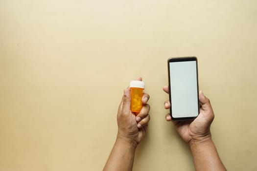 young man hand holding medicine pill container .