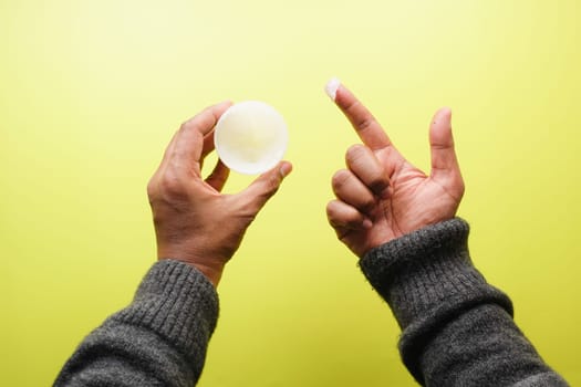 Close up of man hand using petroleum jelly .