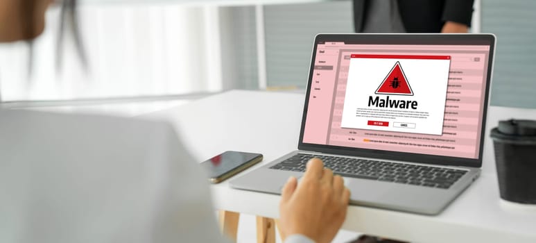 Cyber attacking concept. Malware alert showing on computer screen display scam and threat detection on computer system or online server to be removed snugly.