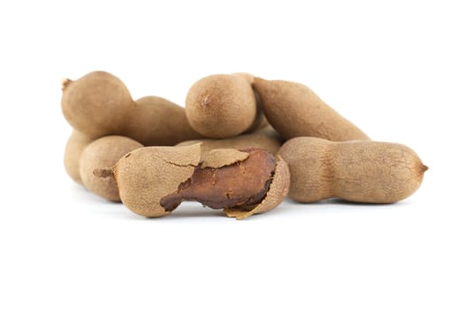 Tamarind fruits, whole and cracked open isolated on white background (Tamarindus indica)