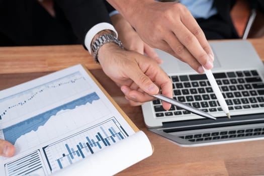 Diverse group of business analyst team analyzing financial data report paper on office table. Chart and graph dashboard by business intelligence analysis for strategic marketing planning Habiliment