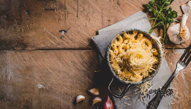 mac and cheese with corn, bacon topped with panko breadcrumbs on plate on dark wooden table