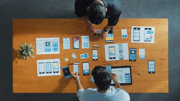 Top view of software developer working on Ux Ui design while team working together to brainstorm and develop wireframe prototype designing at creative digital company. Teamwork concept. Convocation.