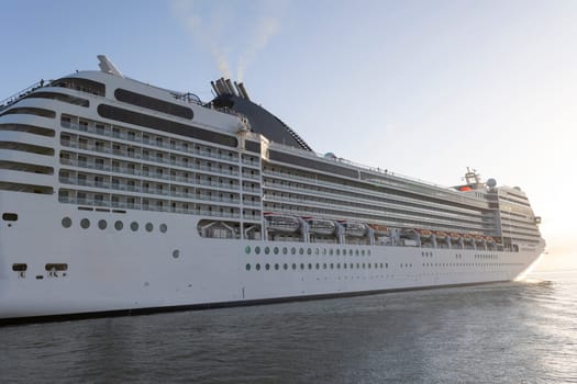 A large cruise ship with the letters MSC on the side. The ship is white and has a large black star on the side