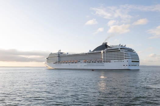 A large cruise ship with the letters MSC on the side. The ship is sailing in the ocean