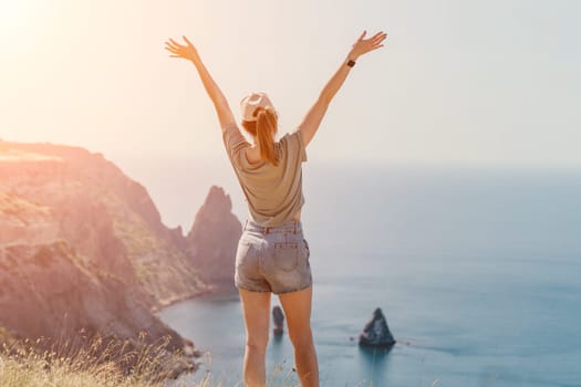 Woman travel sea. Happy carefree sensual woman with long hair in black swimwear posing at sunset beach. Silhouette of young beautiful playful positive woman outdoor. Summer vacation and trip concept