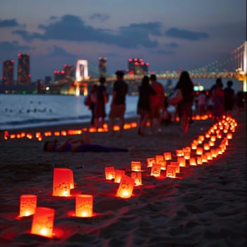 Paper lanterns create a winding path on the beach, with a festive atmosphere under the dusky sky near a citys glowing bridge. Japanese Marine Day Umi no Hi also known as Ocean Day or Sea Day.