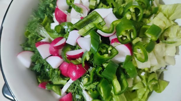 fresh green salad with radishes, cooking food, summer dish, snack. High quality photo