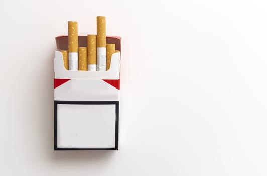 Open pack of cigarettes and a cigarette on a white background. High quality photo