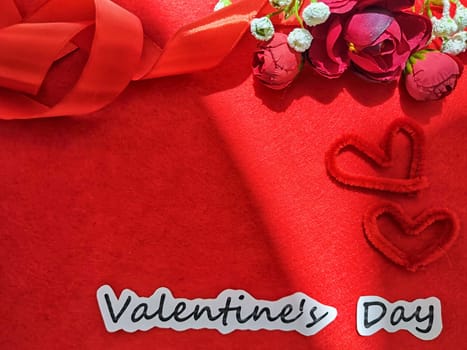 Valentine's Day concept celebration, congratulation. Red greeting Card with flower, Satin ribbon for Background, texture, place for text, copy space