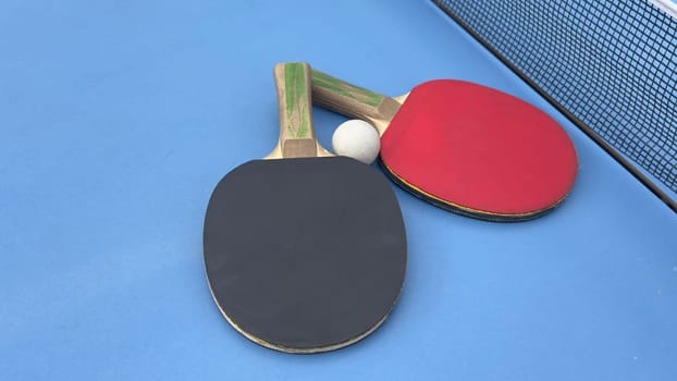 Table tennis rackets and ball on tennis table. High quality photo