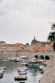 Boats stand on the pier near the fortress walls of the old town of Dubrovnik. Croatia. High quality photo