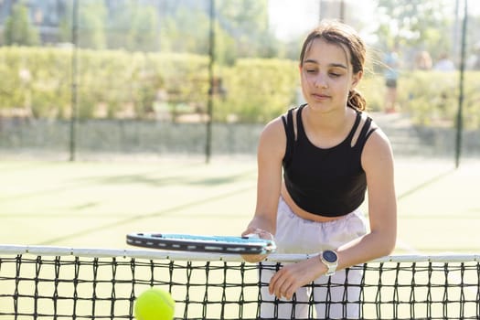 Girl with a racket on the tennis court. High quality photo