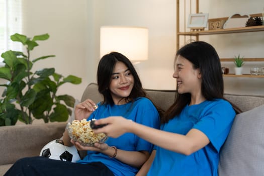 LGBT Soccer fans emotionally watching game in the living room.