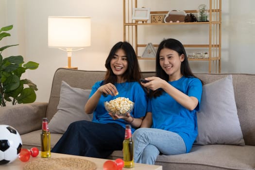 LGBT Soccer fans emotionally watching game in the living room.