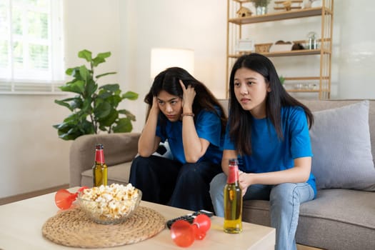 LGBT Soccer fans emotionally watching game in the living room.