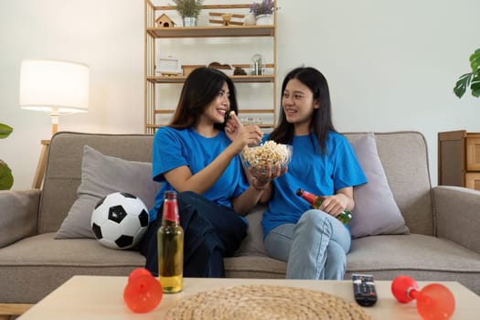 LGBT Soccer fans emotionally watching game in the living room.