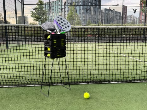 Background of padel racket and ball on artificial grass floor in outdoor court. Top view. High quality photo